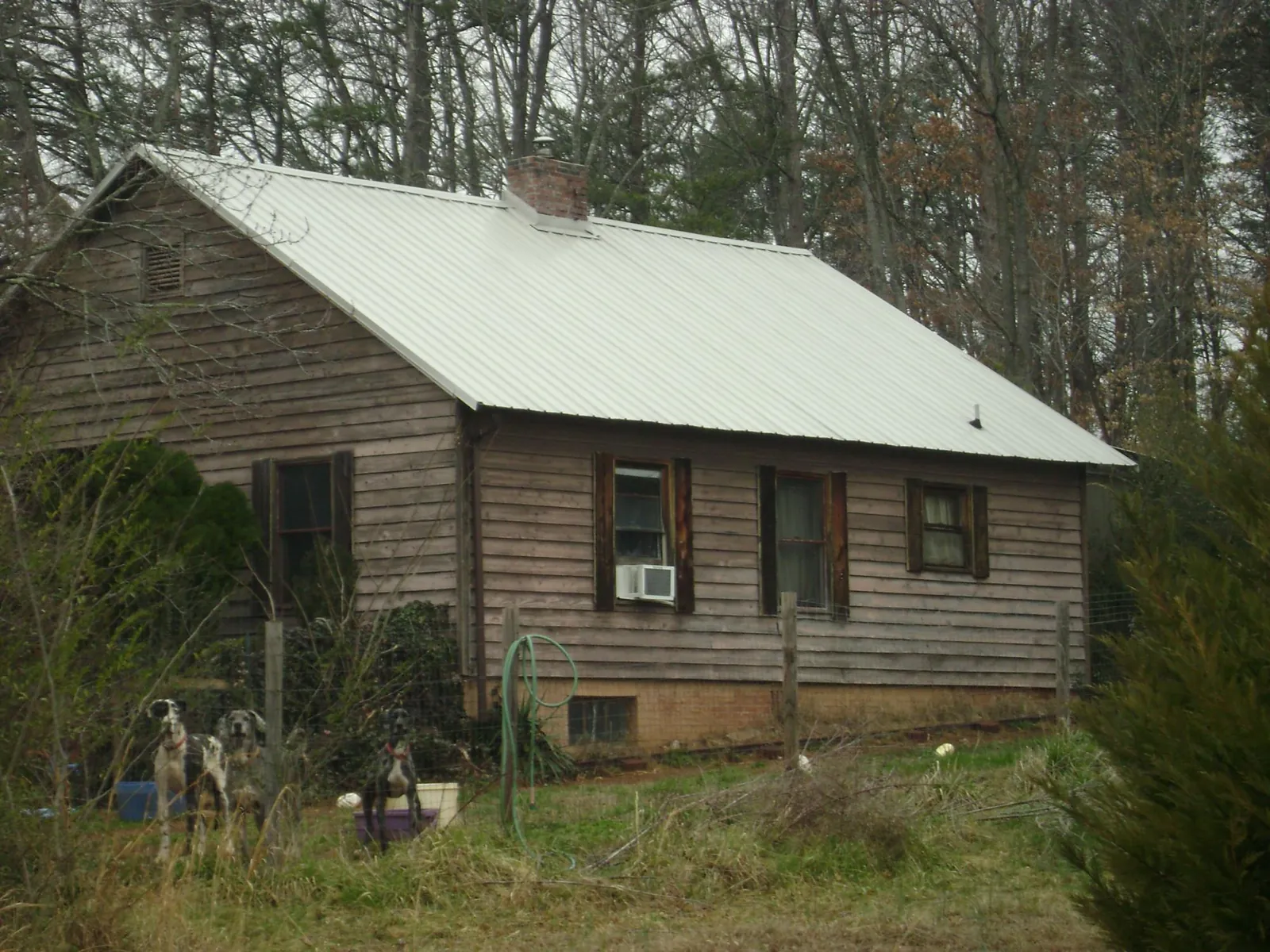 White metal roof on an old wood sided farmhouse, from a Asphalt Shingle Roof Repair job in Hubbardston